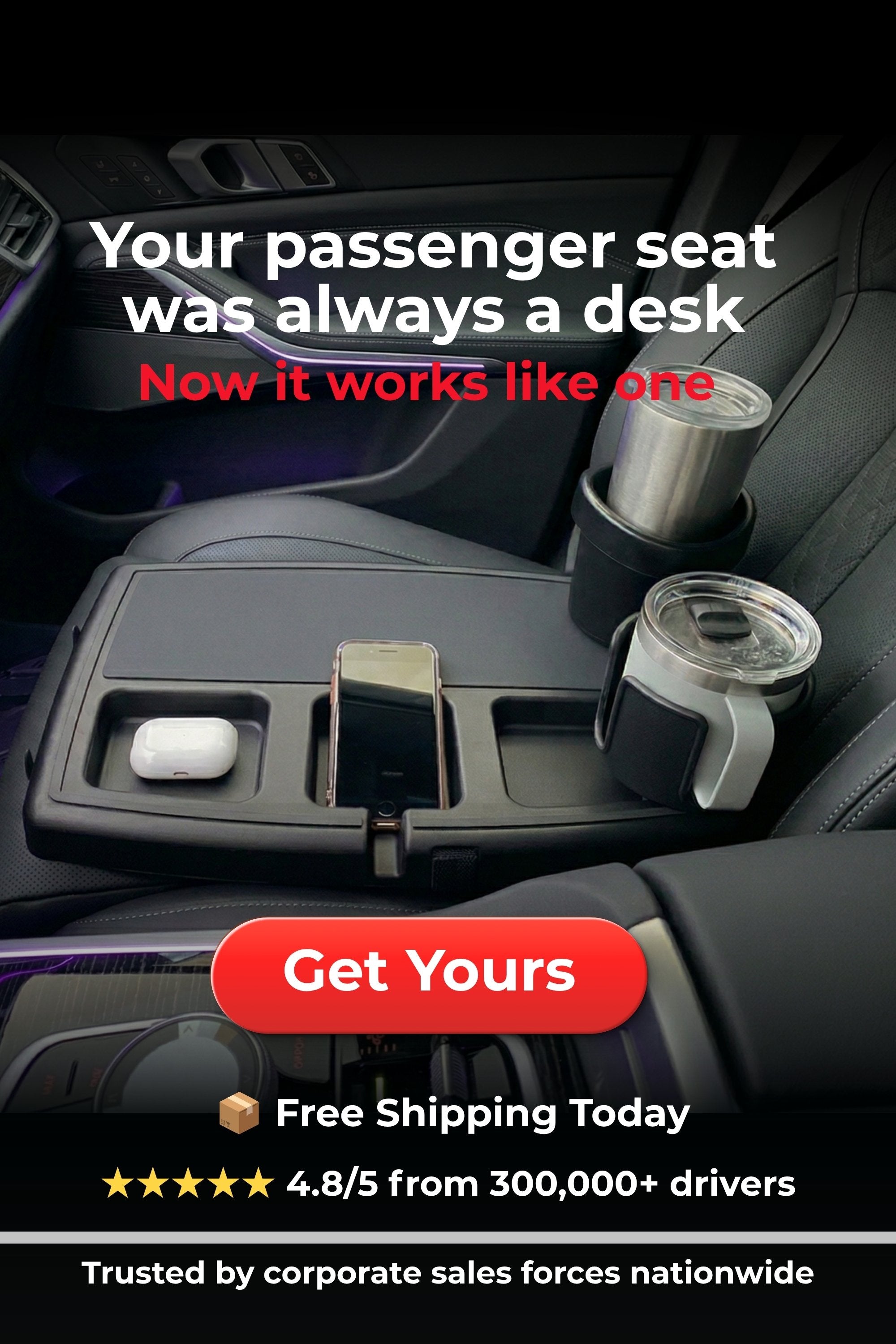 Car interior with a desk setup, cup holders, and phone holder.
